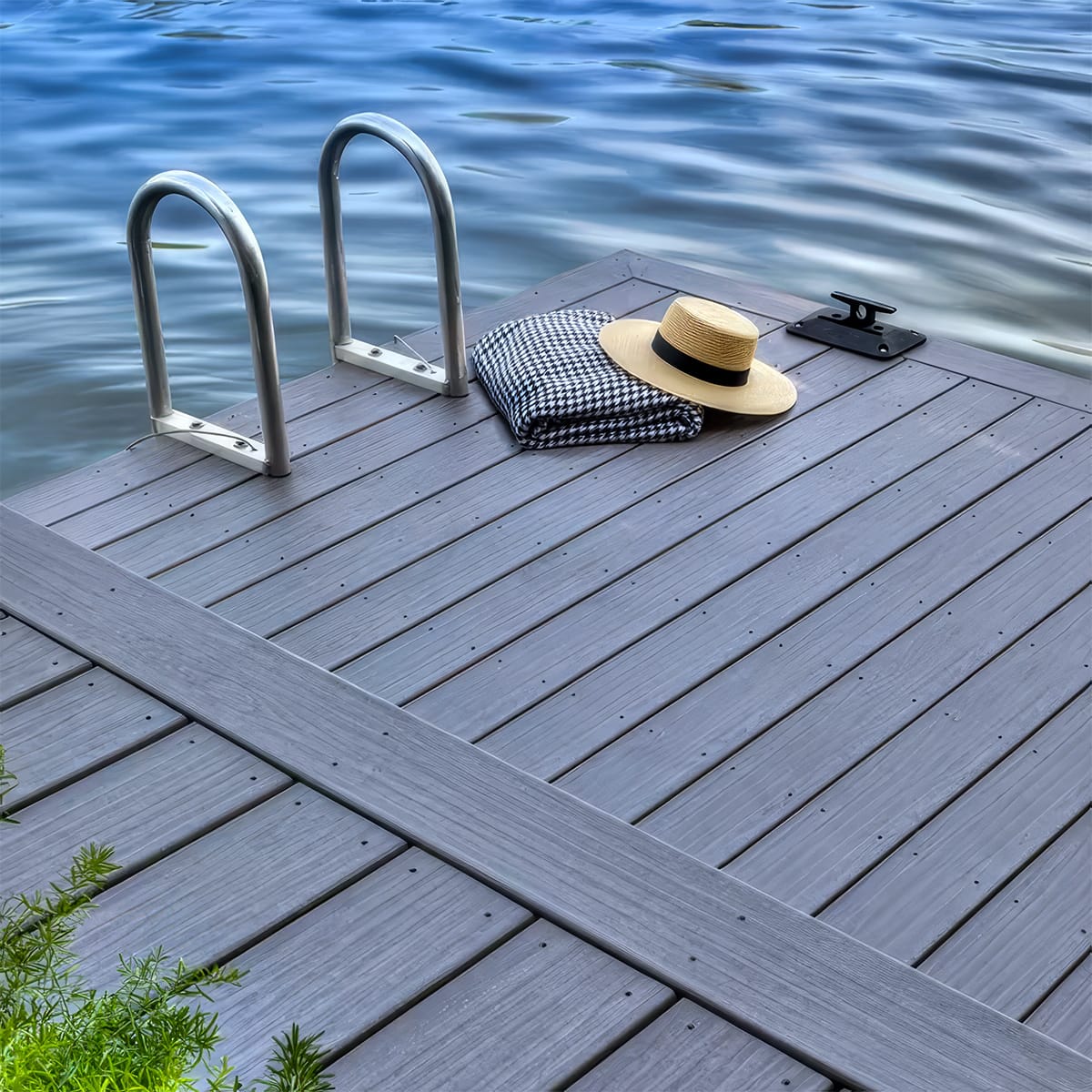 Gray composite decking on a Lake Martin dock with a swim ladder and boat cleat, installed in a diagonal pattern with picture-frame border